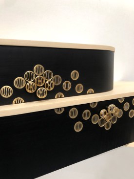 The Astral console, designed by Studio Line & Raphaël marries the timeless charm of marquetry with new technologies like 3D printing. The marriage of brass and laser-cut black pear wood veneer creates a visually captivating combination, bringing elegance and refinement to any interior space.