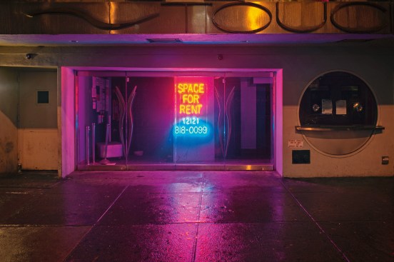 Neon Sign, West 50th Street, New York“A glowing light drew my attention at the intersection, because the entire block was quite dark due to the several vacant stores. The sign appealed to me because of the cheerful colors and glowing neon light. Normally, I might not have paused to look at this place, but the pink and blue light allowed me to concentrate on the basic architectural structure of the storefront. Without products, normal signage, or mannequins in the window, I could see the place in its own glory.” -- Lynn Saville