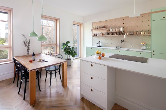 Several layers of insulation were added to the front and rear façades to bring the house up to Passive House standards, resulting in deep sills. The remodeled kitchen has only electric GE and Miele appliances to avoid the use of natural gas. 