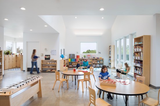 Lower elementary classroom with diamond-polished concrete floors and view to classroom garden at right.