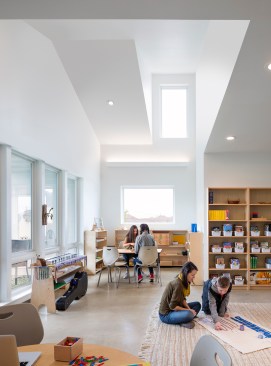 Upper elementary classroom, with view to covered back porch at left.