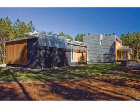 Jury Selections - Third Place:  GREENville House, Greenville, N.C.  Architect: Vinny Petrarca, Tonic Design  Builder: Tonic Construction  Architect’s description:  The 
GREENville House/Walters Residence is composed of two primary design components: bars and panels. Each part works together to generate an environmentally sensitive response. Narrow bars branch out into the landscape to create courtyards, capture natural light, allow cross ventilation, and intersect to form a central volume of double-height public space. A structural system holding photovoltaic panels and perforated screens is responsible for creating the home’s energy and hot water while shading openings to alleviate unnecessary heat gain.  &nbsp;  Jurors’ comments:  A large and ambitious house with many materials and details. Well-proportioned and vigorous, the house displays an uncommon passion for architecture. The materials and forms are stitched together like a beautiful quilt.