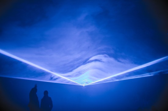 "Waterlicht'"by Studio Roosegaarde is a virtual flood that uses LED technology, software, and lenses to produce wavy rays of light. The installation shows how high water could reach if humans continue to ignore sea level rise.