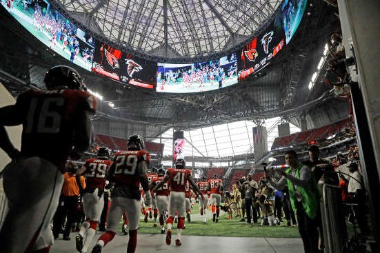 Atlanta Falcons enter the field of their new home stadium.