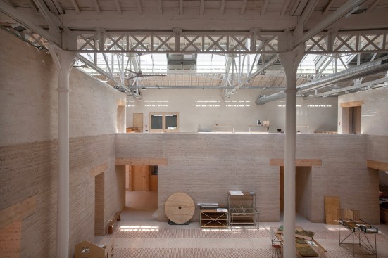 Rammed-earth and CEB block walls inside Le Magasin Électrique.