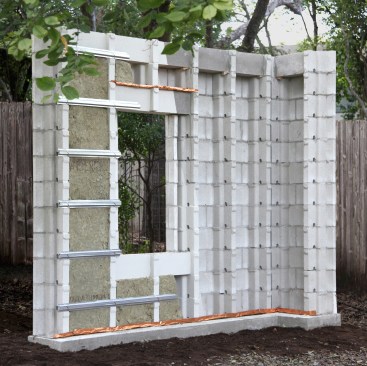 Full-scale mock-up showing installation of flashing, bond-beam units, horizontal rebar, and metal furring via stainless steel zip ties