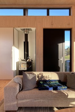 Constructed from prefabricated cross-laminated timber modules, the self- self-sustaining, off-the-grid house looks out to the mountains in Geraldine, New Zealand.