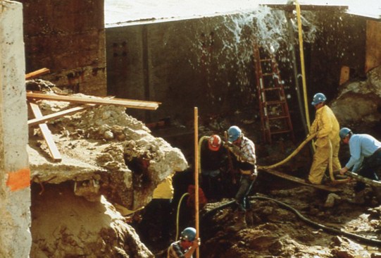 Construction workers race against the tide to place the aquarium's concrete foundation (circa 1982).