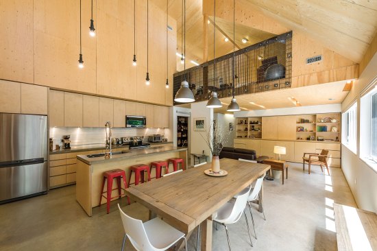 Lofted art spaces look into Moore Studio’s double-height kitchen.