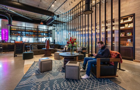 The second-floor lobby features an open plan and a variety of seating areas, all outfitted in furnishings and finishes inspired by the area's history in the fashion industry.