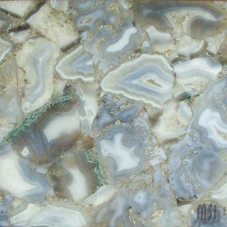 The Semi Precious Collection is made from natural stone pieces such as quartz, amethyst, and agate that are bonded with resin and formed into slabs. Panels are then cut into large-format sizes measuring 96 inches by 48 inches. Pieces can be back lit and used for cladding, countertops, and vanities. 
www.msistone.com.