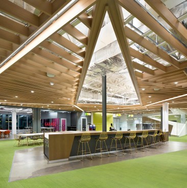 A communal coffee bar, flanked by a maker space called the Garage (at left) and the seventh-floor lobby (at right)