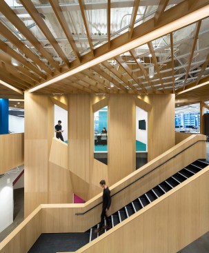 A central, wood-clad stair connects the two levels