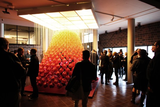 “Myth,” installed in Chicago, re-imagines the ornate and often kitsch assembly of home shrines with suspended handmade candles that regress from a clean finish at the top to a rusticated, morphing look toward the bottom.