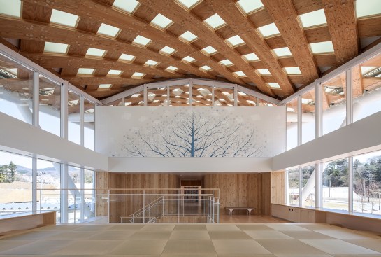 The underside of the lattice structure is visible from the public plaza and esplanade that have been added to the station, which also features white tile painted with wilderness scenes in the spa. 