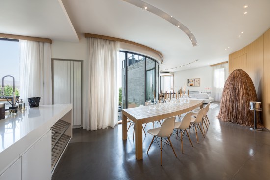 Inside, on the top floor, the architects created a dining table that follows the curve of the room.