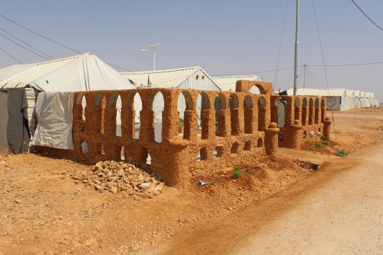 A cultural shelter/adobe interpretation of the Palmyra Arch of Triumph, Al Azraq Refugee Camp, Jordan, 2017