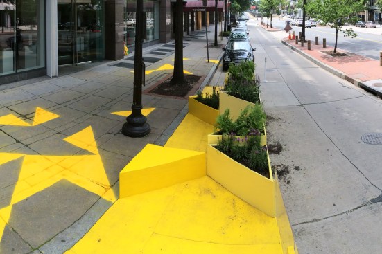 The original design, pictured above, included chalk triangles on the sidewalk. According to the designers, rain has since muddled these sidewalk designs.