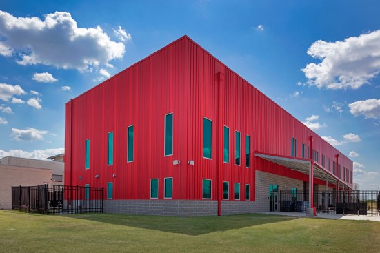 Highline S1 panels are mounted vertically and alternated in three custom red finishes to create a shadow-suggesting ripple effect.