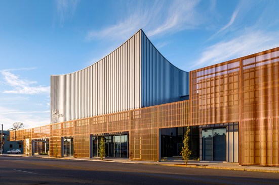 A perforated natural copper screen creates a dynamic façade for Ballet Memphis, located within the Overton Square entertainment district in Memphis, Tenn.