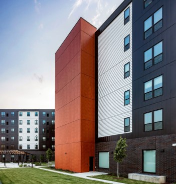 Matte Black Flush panels, Bone White 7.2 Rib panels and custom “Super Douglas” Wood Grain finish panels, all from PAC-CLAD, provide a dynamic façade that was easy to install, long-lasting, and cost-effective.