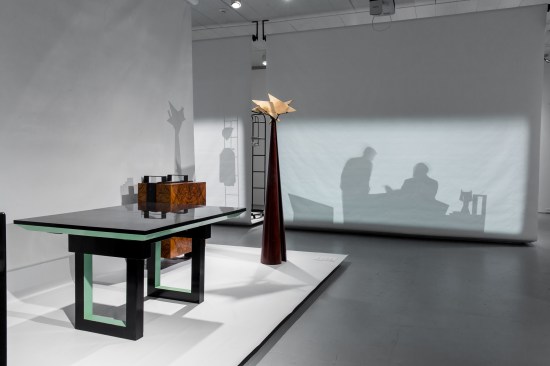 Image of the exhibition showing a bicolor table designed by Chareau (1927)
