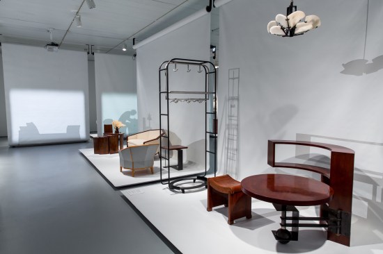 View of the exhibition showing a table/bookcase designed by Chareau (c.1930)
