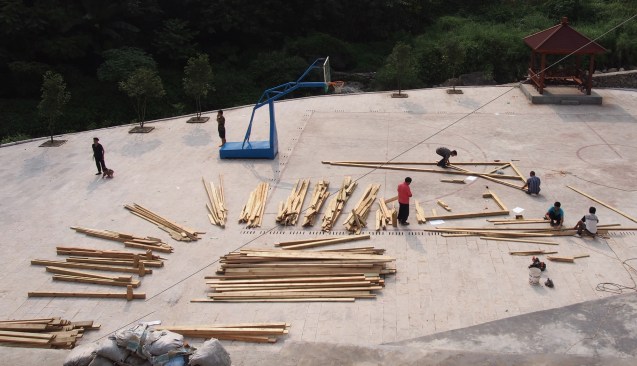 Construction workers drew templates on the concrete plaza floor for use in construction.