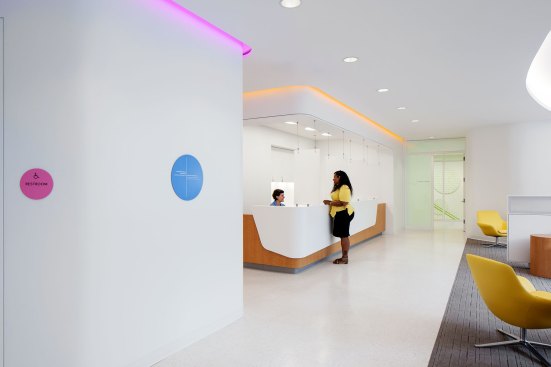 The front desk area. Colored coves provide a contrast to the white interiors.