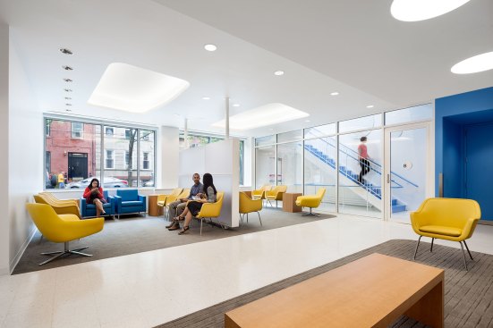 The waiting room. Ceiling pop-ups are lit with linear LEDs and help define the seating areas below.