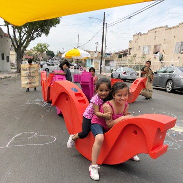 Children play with “Wobbles” designed by KDI as part of the Play Streets program, which enables neighborhoods in Los Angeles to create pop-up recreation areas.