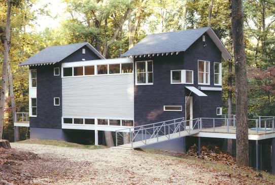 Hoisting the building off its sloped site allowed for a low-tech drainage system; rainwater flows right under the house and down the hill.