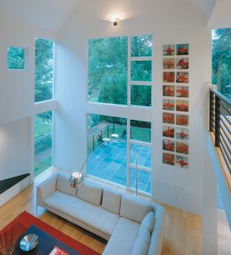 Glass panels in the great room capture the northern light and leafy backyard views.