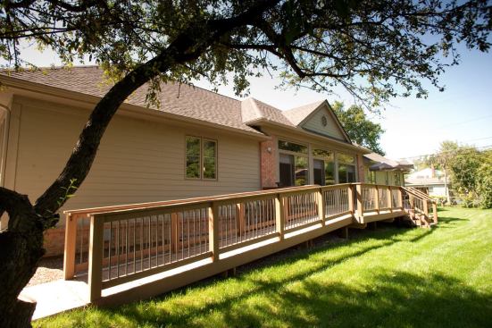 The wheelchair-accessible entrance ramp is discreetly hidden along the side of the house.