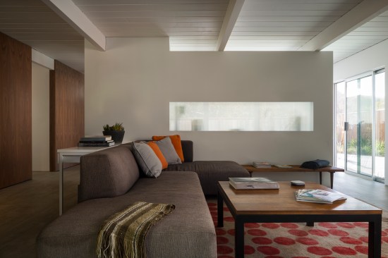 A transluscent panel was installed in the space between the kitchen and the living room, giving people in the living room a sense of what's cooking.
