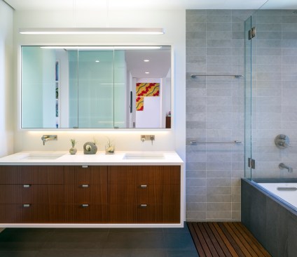 The full bathroom renovation took advantage of linear design called for in the original whole-house remodel, extending the geometric feel of the space up the walls and across the floors.