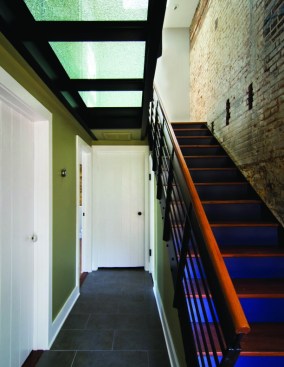 The second-floor walk in the Cork Street apartment is glass, allowing natural light to pass through.