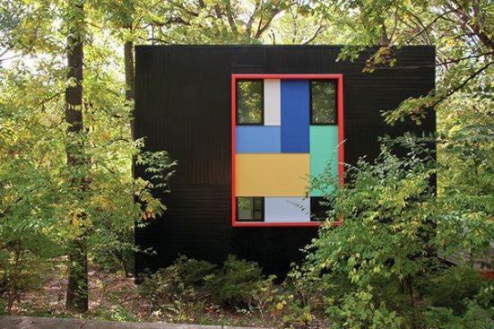 Four windows and a collection of brightly colored attachments enliven the black metal exterior. The playful colors that pop up here and throughout the house echo one of the paintings in Richard Diebenkorn's "Ocean Park" series.
