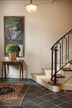 The new stairs spill elegantly into the hallway to welcome guests. Wills replaced the dated wooden handrail with a custom designed iron hand and shoe rail, with curved balusters. The curved molding echoes the railing aesthetic yet gives a nod to the home’s traditional background.