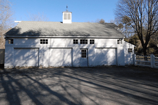 The shallow overhangs on this 1,700-square-foot carriage house caused water to splash off the roof and onto the bottom of the structure, causing the siding to rot.