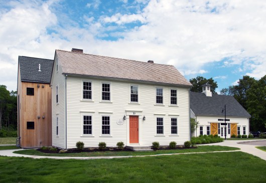 Front view of the restored tavern with 9 Harvey Majesty Wood windows with high energy efficiency glass and classic colonial grid pattern.