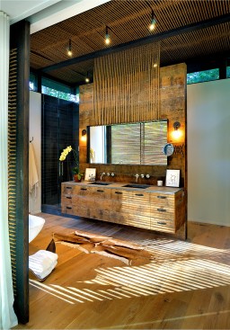 The
new bathroom cabinetry is also made of refurbished wood, with the large mirror
hanging from the natural rope.