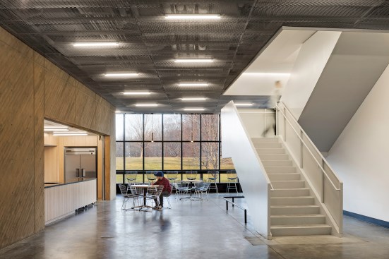 Some interiors, such as the addition’s lobby (shown), are frequented by the performance-going public. Concrete helps the space also withstand hard use by students. 