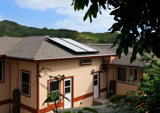 Highly reflective roof shingles alleviate solar heat gain, and solar panels collect energy for the home’s hot water system.