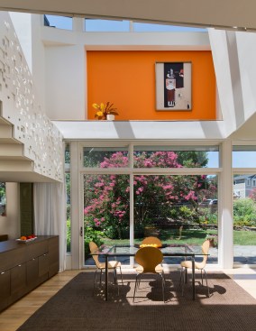 Rather than add on a porch to the exterior of the home, Ray opted to fulfill that desire by opening up the side of the house to the outdoors with large windows and sliding glass doors.