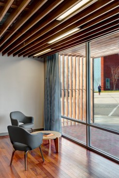 The entry lobby and arbor of Benson Hall with expansive windows and new lighting fixtures between wooden slats.