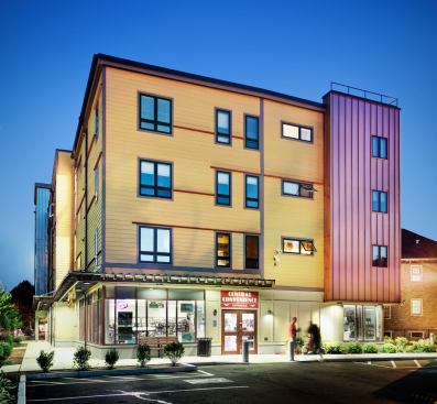 The 24-unit building has three ground-level retail shops, including a grocery store. Timers and photo sensors control exterior lighting.