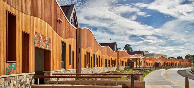 A footbridge leads to an entrance of the new school