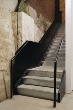 Stairway connecting exhibition hall to lower level galleries.