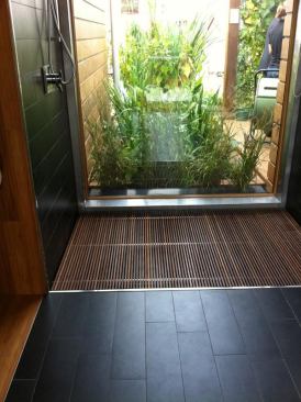 A large window in the bathroom offers a view to the outdoors, while an on-site wetland helps filter and recycle greywater from the shower, clothes washer, and dishwasher.